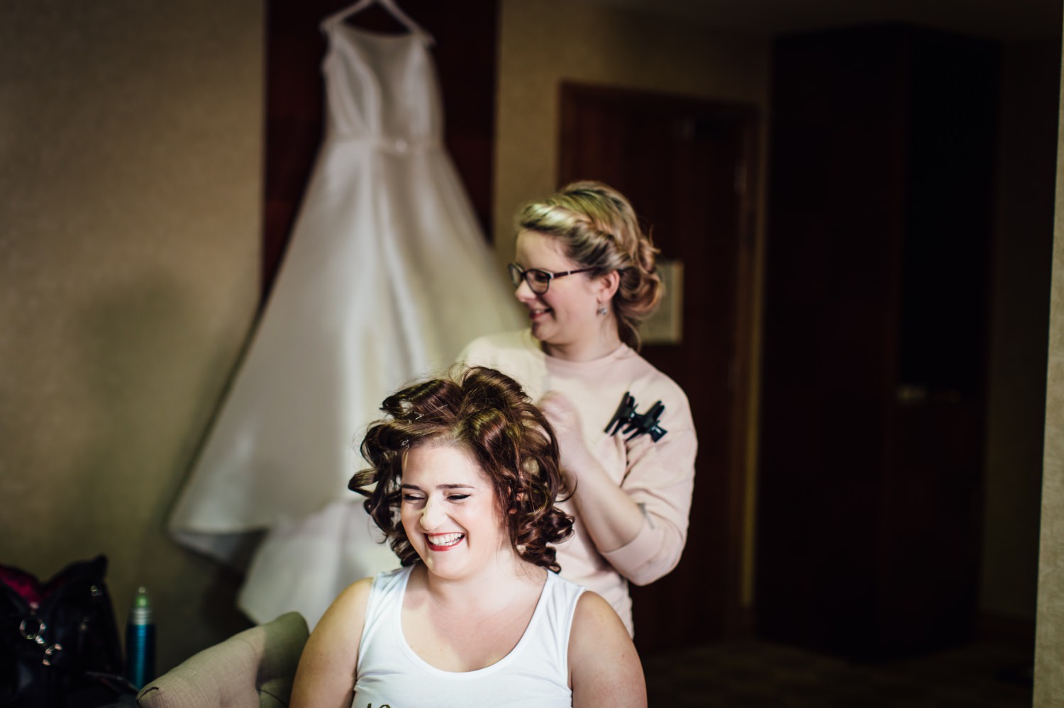 Bride having her hair done in the morning