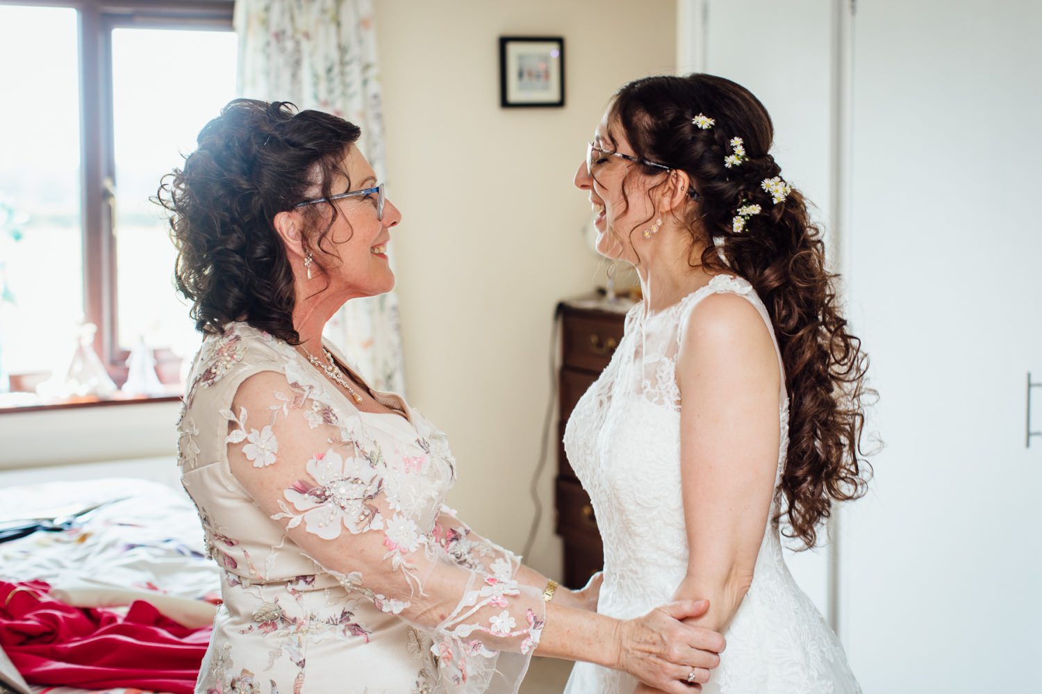 mother of the bride hugging her daughter