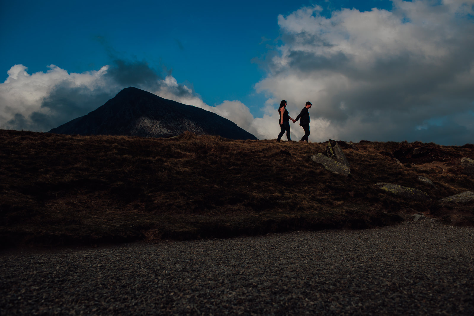 silhouette by mountain of couple
