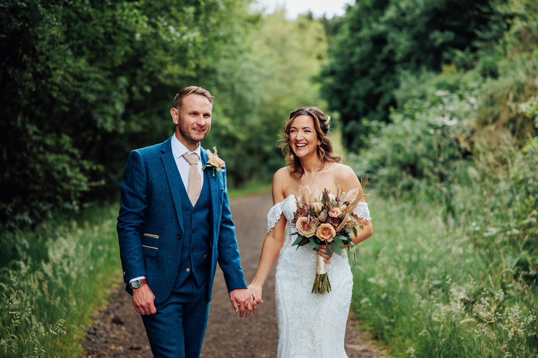 bride and groom by lake in Delamere, Cheshire