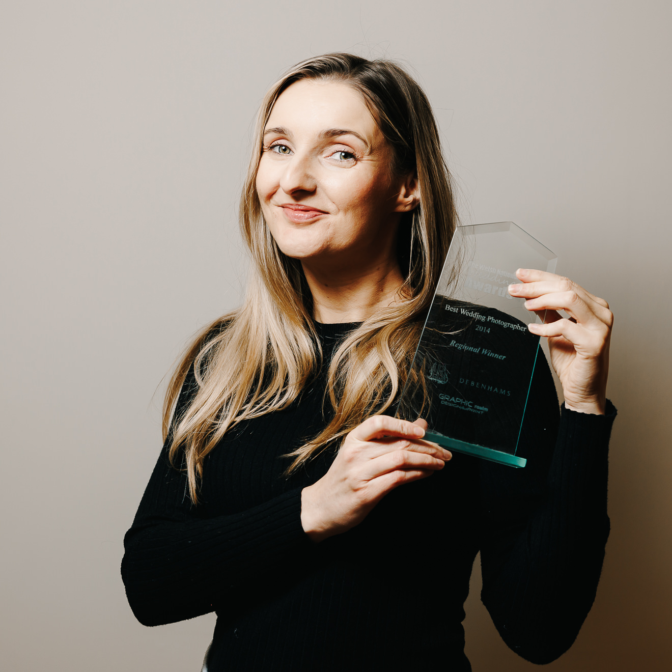 Photograph of Marie Lloyd holding an award