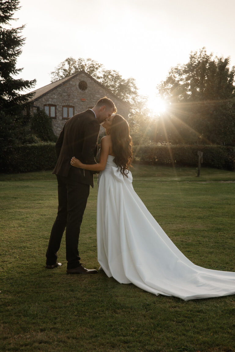 Sunset photo with couple kissing in Vale country club grounds