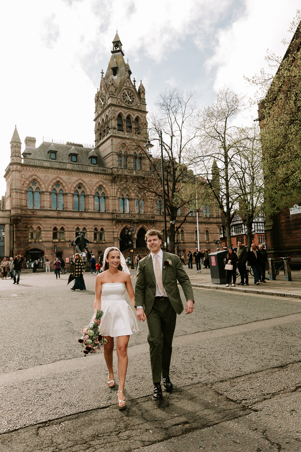 Newlywed couple walking in front of Chester Town Hall