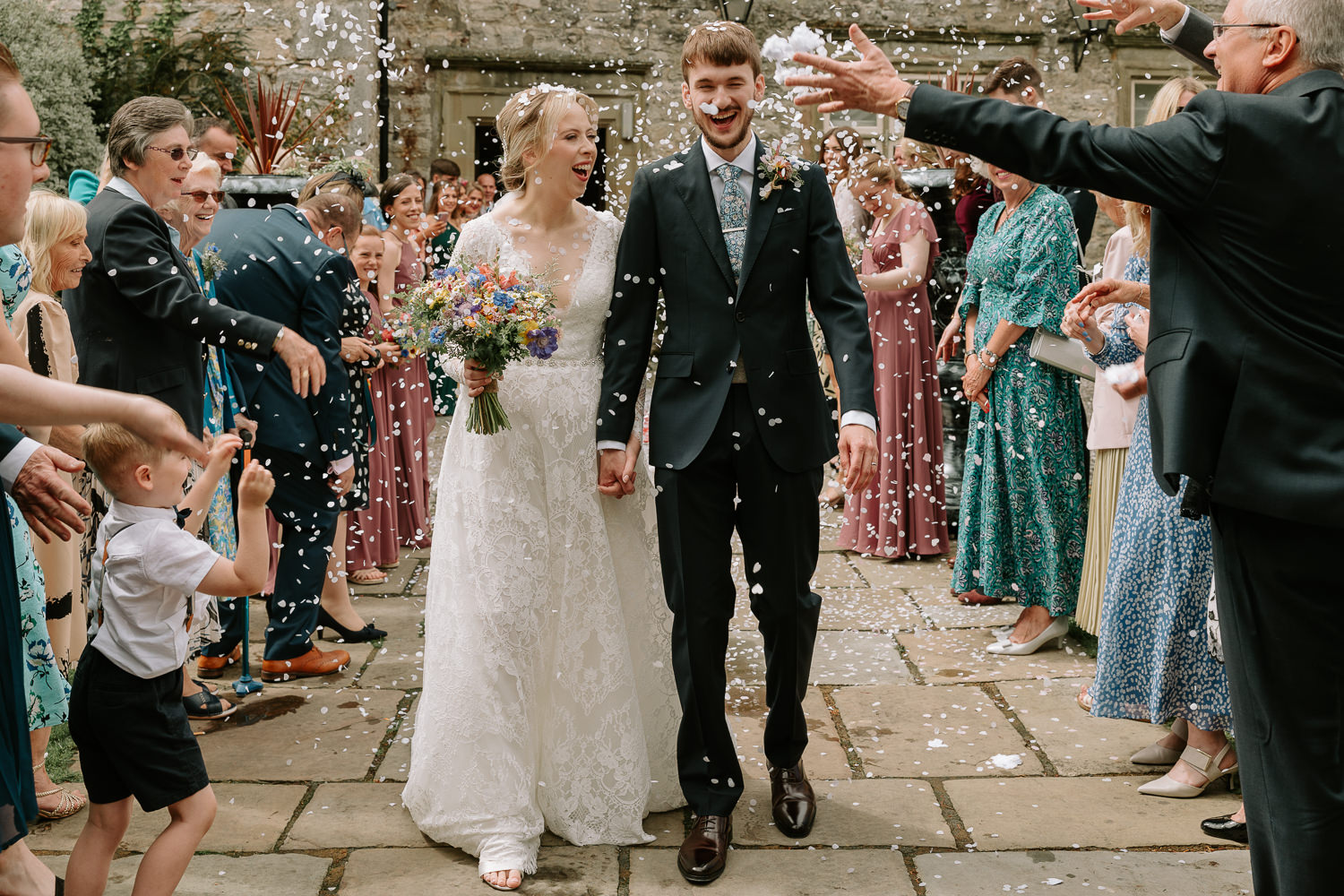 Newlyweds celebrating with confetti shower.